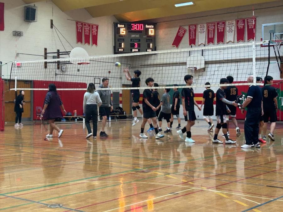 Students on the volleyball team warming up for a volleyball match